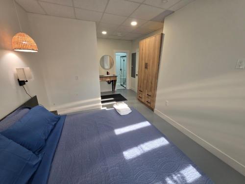 a bedroom with a bed and a hallway with a desk at Lakeview Main Floor Suite 104 in Peachland