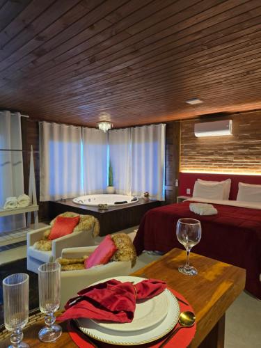 a room with a bed and a table with a plate on it at Chales Vidal in Venda Nova do Imigrante