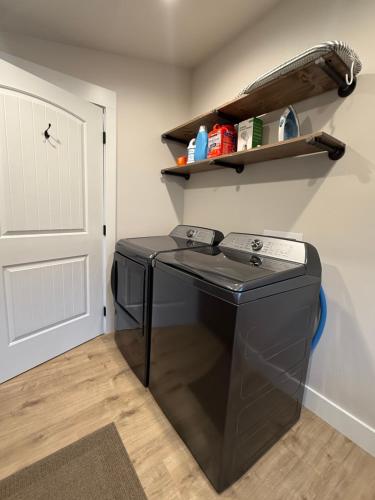 a washing machine in a room next to a door at Home Town Mountain Lodging 2 in Darby