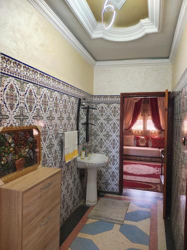 a bathroom with a sink and a bed at Villa Drayd in Ait Melloul