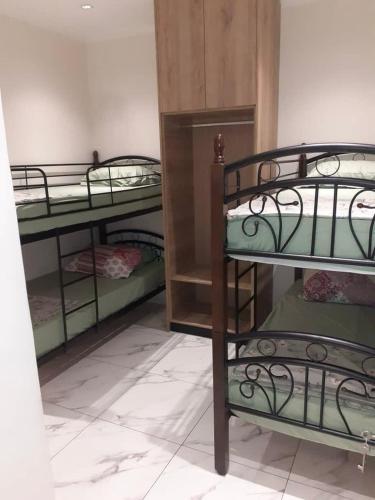 a room with three bunk beds in a room at Le gîte in Tefeschoun