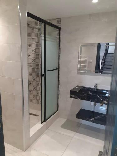 a bathroom with a glass shower and a sink at Le gîte in Tefeschoun