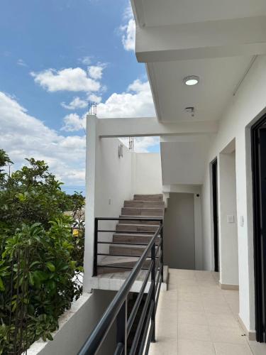 a balcony of a building with stairs on it at Casa Flor in San Antonio de la Cal