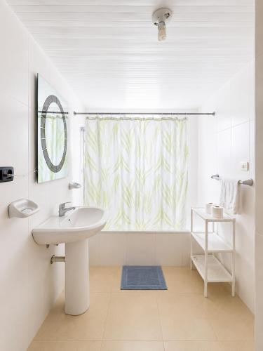 a bathroom with a sink and a shower curtain at 1 Sol Dominicus Solo Adultos Habitación con Entrada Independiente y Baño Privado in Bayahibe