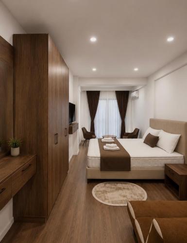 a bedroom with a bed and a couch and a table at Euro Hotel in Peje