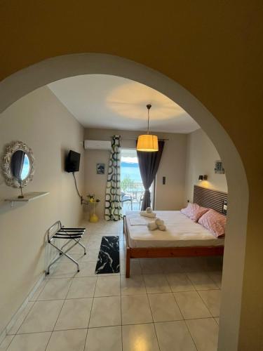 a bedroom with a bed and a room with a window at Alisaxni Studios in Pefki