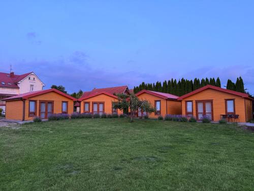 a row of houses with a yard in front of them at Willa Aleksander in Rewal