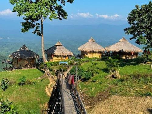 a group of huts on top of a hill at SA Housing 2 in Rangpur
