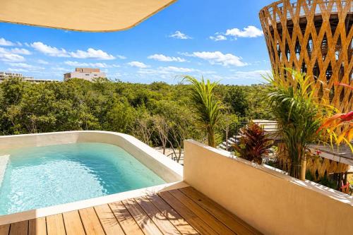 a swimming pool on the deck of a house at Mayan View Walk to Beach & Tulum Ruins in Tulum