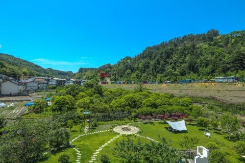 an aerial view of a garden with mountains in the background at Pure House--Free shuttle Service to South Gate of the Forest Park,Attraction Tickets Serivce in advance, Mount View, Nature village and Tranguility in Zhangjiajie