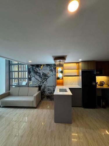 a kitchen and living room with a couch and a table at Luxury Loft at Crown Regency in Cebu City