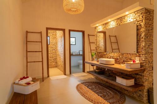 a bathroom with a sink and a mirror at Villa Florens in Jericoacoara