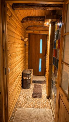 a hallway of a wooden cabin with a door at The DACHA escape in Viimsi