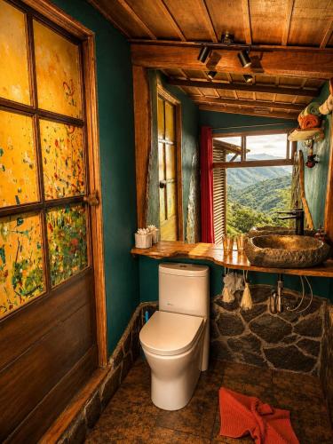 a bathroom with a toilet and a sink at El Sol Monteverde in Monteverde Costa Rica