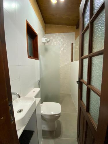 a bathroom with a toilet and a sink and a shower at Chalés Mar & Mata Paraty in Paraty