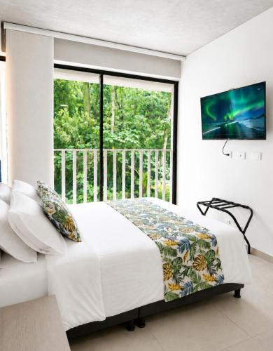 a bedroom with a bed and a large window at Apartamento Armenia in Armenia