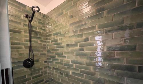 a shower with a brick wall in a bathroom at Sugar Loaf Lodge in Sedona