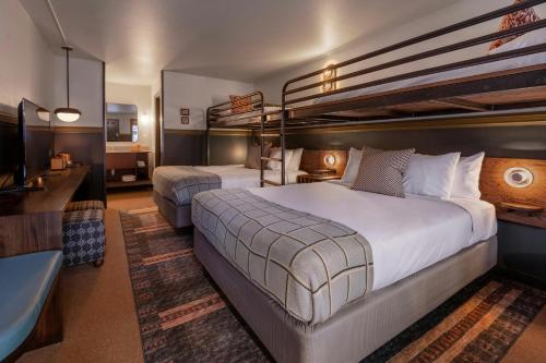 a hotel room with two bunk beds and a television at The Ozarker Lodge in Branson