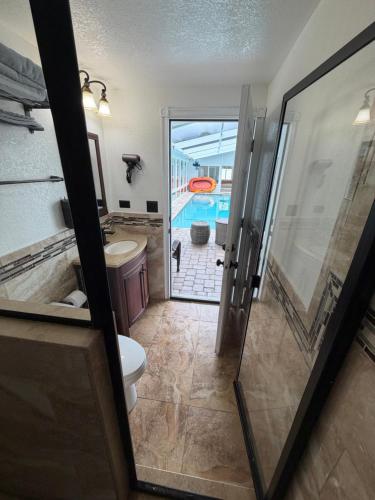 a bathroom with a shower and a toilet and a sink at Welcome to Villa Marcelo in Tampa