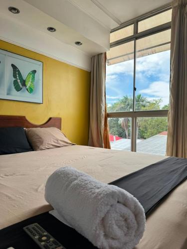 a bedroom with a bed with a towel on it at Hotel Confort Amazónico in Iquitos