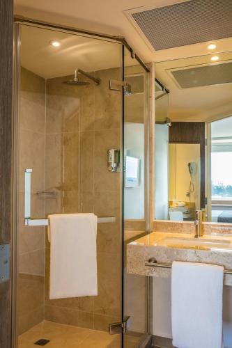a bathroom with a shower and a sink at One Coatzacoalcos Forum in Coatzacoalcos