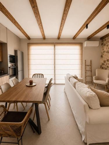 a living room with a white couch and a table at Terra boho apartment in Ambelákia