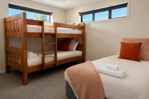 a bedroom with two bunk beds and a window at Sefton View in Lake Tekapo