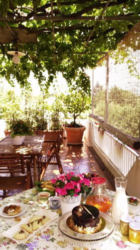 a table with plates of food on a patio at Giogaia in Modica