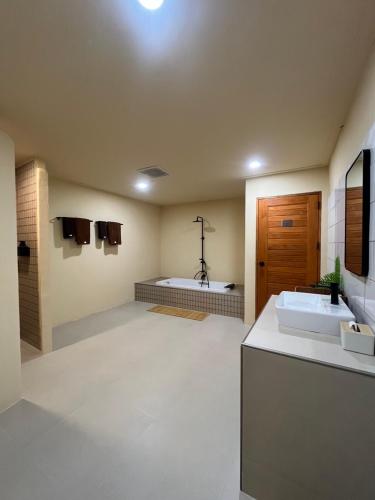a large bathroom with two sinks and a tub at Pani house in Ko Samed