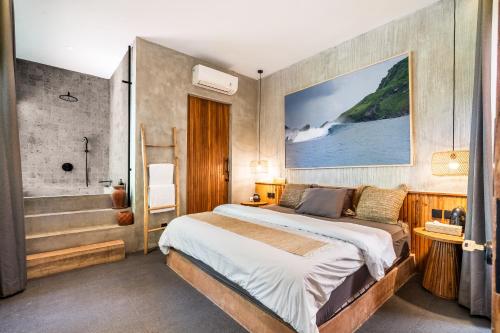a bedroom with a bed and a bath tub at Villa Dinova in Uluwatu