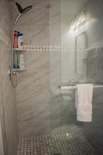 a bathroom with a shower with a glass door at National Harbor Suite 1 in Fort Washington