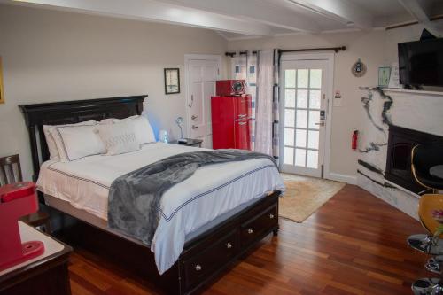 a bedroom with a large bed and a red refrigerator at National Harbor Suite 1 in Fort Washington