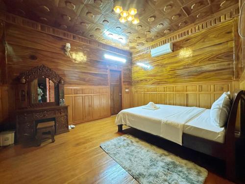 a bedroom with a large bed and a fireplace at Cloudy Hill Homestay and Hostel in Kampot