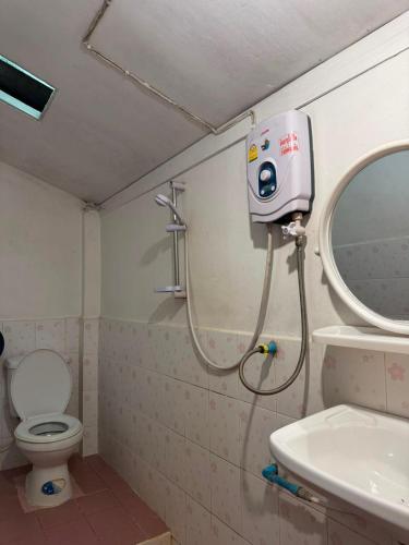 a bathroom with a toilet and a sink and a mirror at Nam Ou Breeze in Ban Ngoy-Nua