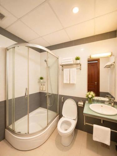 a bathroom with a shower and a toilet and a sink at Vina Boutique Hotel in Hue