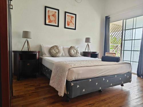 a bedroom with a bed with pillows on it at Waterfront Lodge in Nuku‘alofa