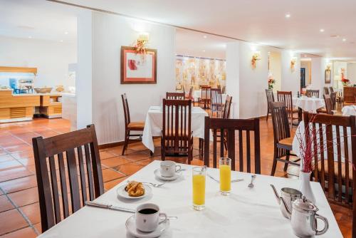 a dining room with a table with food on it at Parador de Manzanares in Manzanares