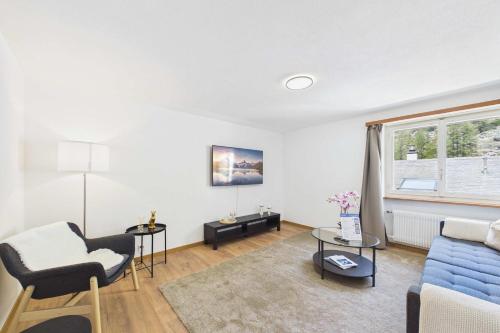 a living room with a blue couch and a blue chair at Alpine Apartment near Saas-Fee for 4 in Saas-Almagell