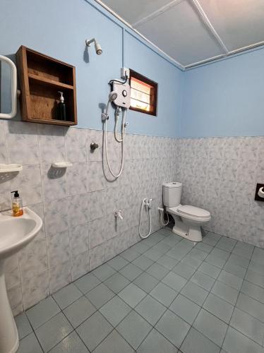 a bathroom with a shower and a toilet at Lobster Inn in Trincomalee