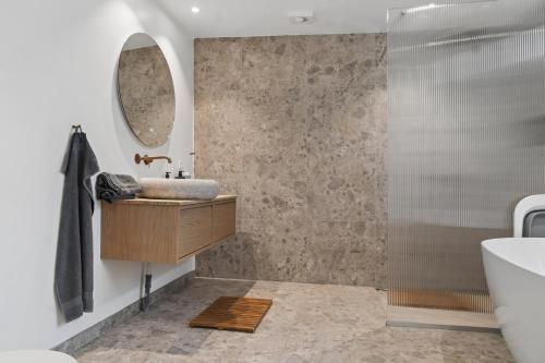 a bathroom with a sink and a mirror at Newly Renovated Cottage With Sauna in Melby