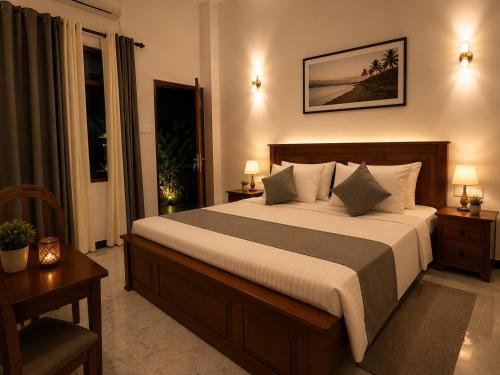 a bedroom with a large bed and a window at Danketiya Palace in Ahangama