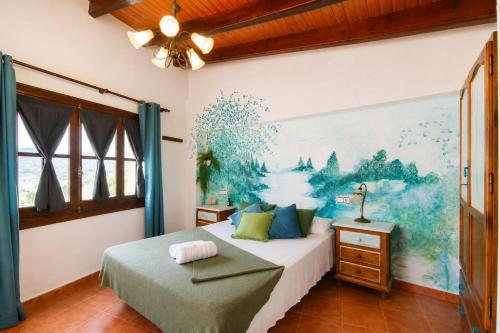 a bedroom with a bed and a painting on the wall at Refugio La Presa in Chulilla