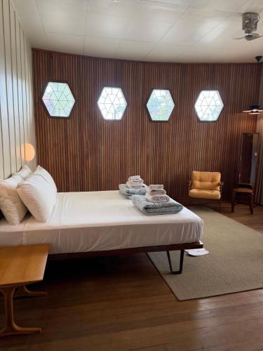 a bedroom with a bed and four windows at The Lewis House in San Juan