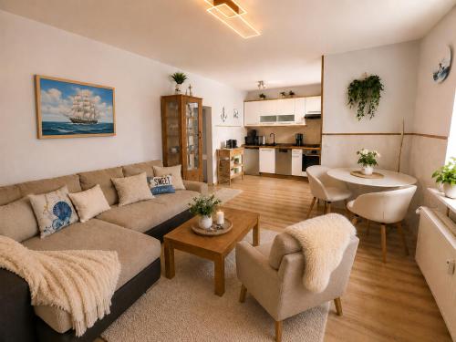 a living room with a couch and a table at Seebad Ahlbeck - Haus MIRAMAR in Heringsdorf
