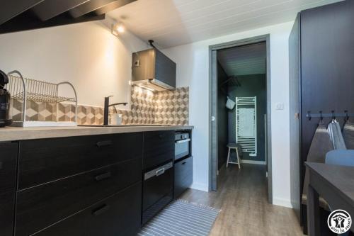 a kitchen with a sink and a counter top at Le sourire des anges in Saint-Élix-le-Château