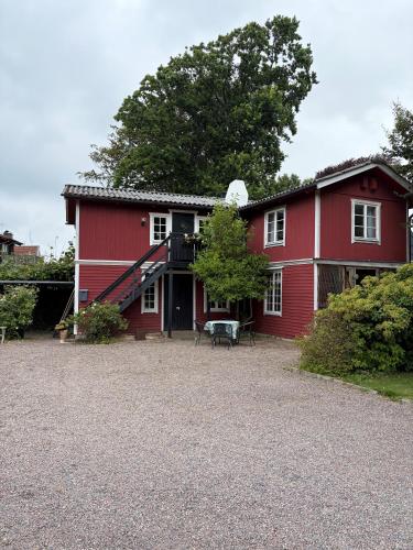 a red house with a staircase in front of it at Valhallsvägen 45 in Ängelholm