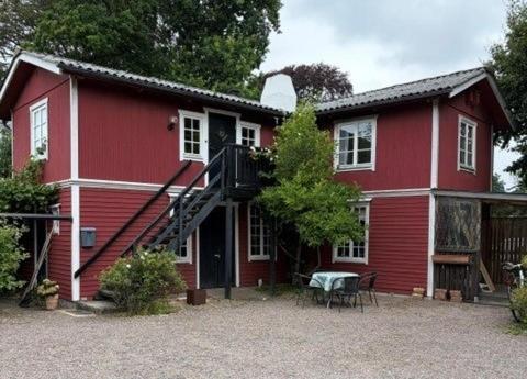 a red house with a staircase in front of it at Valhallsvägen 45 in Ängelholm