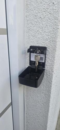 a key in a holder on a wall at Aaberg Lounge in Waldshut-Tiengen