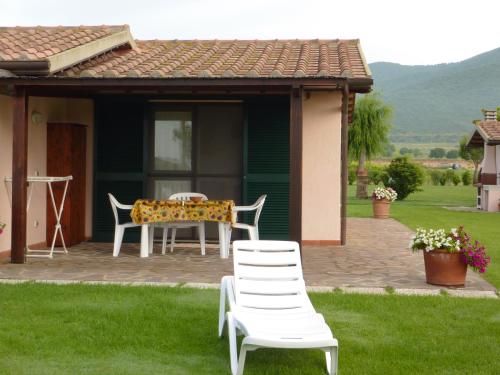 a patio with a table and chairs in front of a house at Agriturismo Bocci in Castiglione della Pescaia