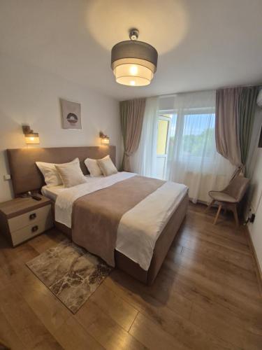 a bedroom with a large bed and a chair at Pension Casablanca in Câmpina